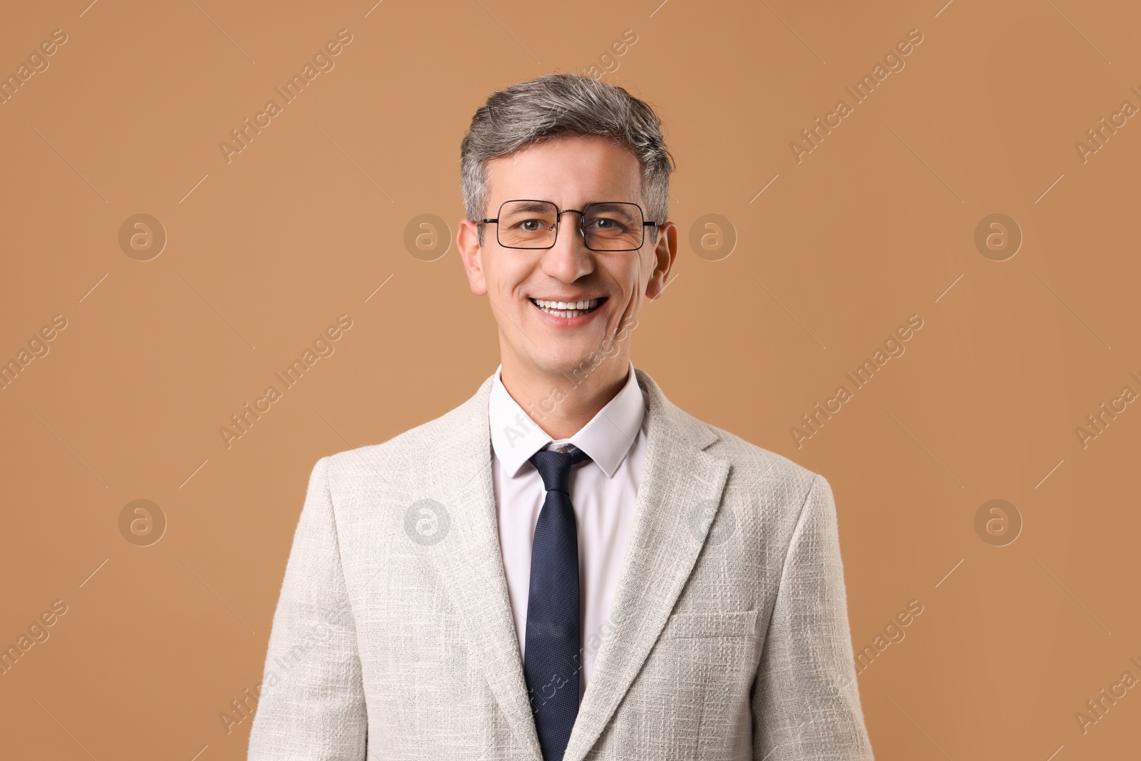 Photo of Portrait of businessman in glasses on brown background