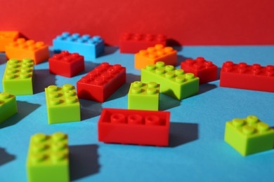 Photo of Construction toy. Colorful building bricks on color background, closeup