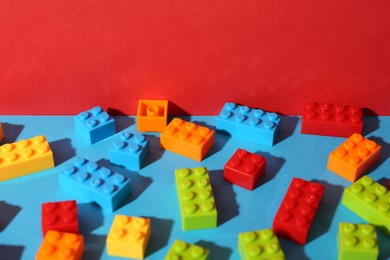 Photo of Construction toy. Colorful building bricks on color background, closeup