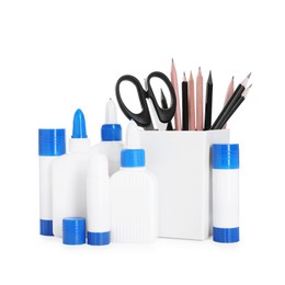 Photo of Different types of glue, scissors and pencils isolated on white