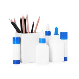 Photo of Different types of glue and pencils isolated on white