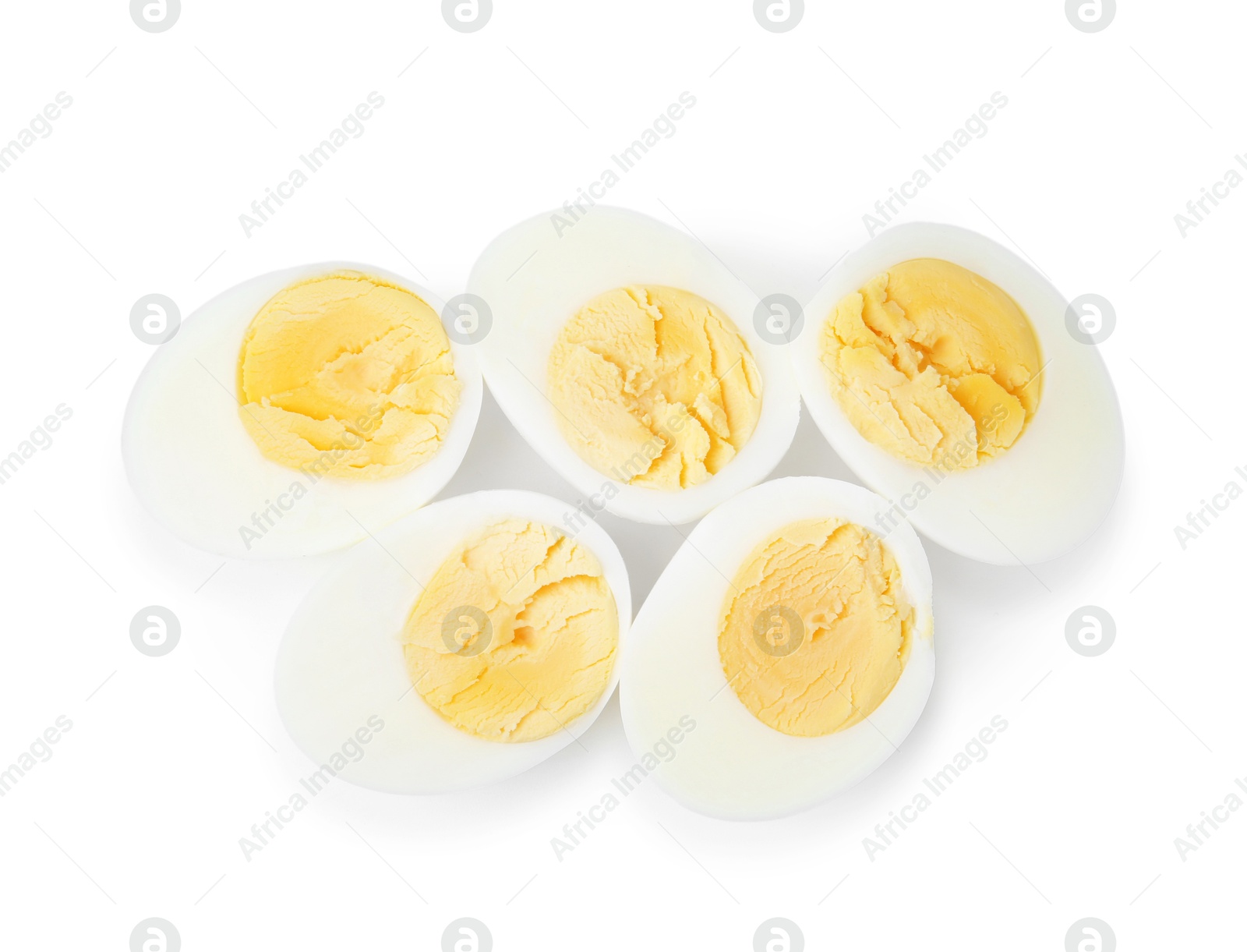 Photo of Halves of hard boiled eggs isolated on white, top view