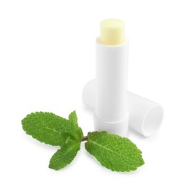 Photo of Mint lip balm and green leaves isolated on white. Cosmetic product