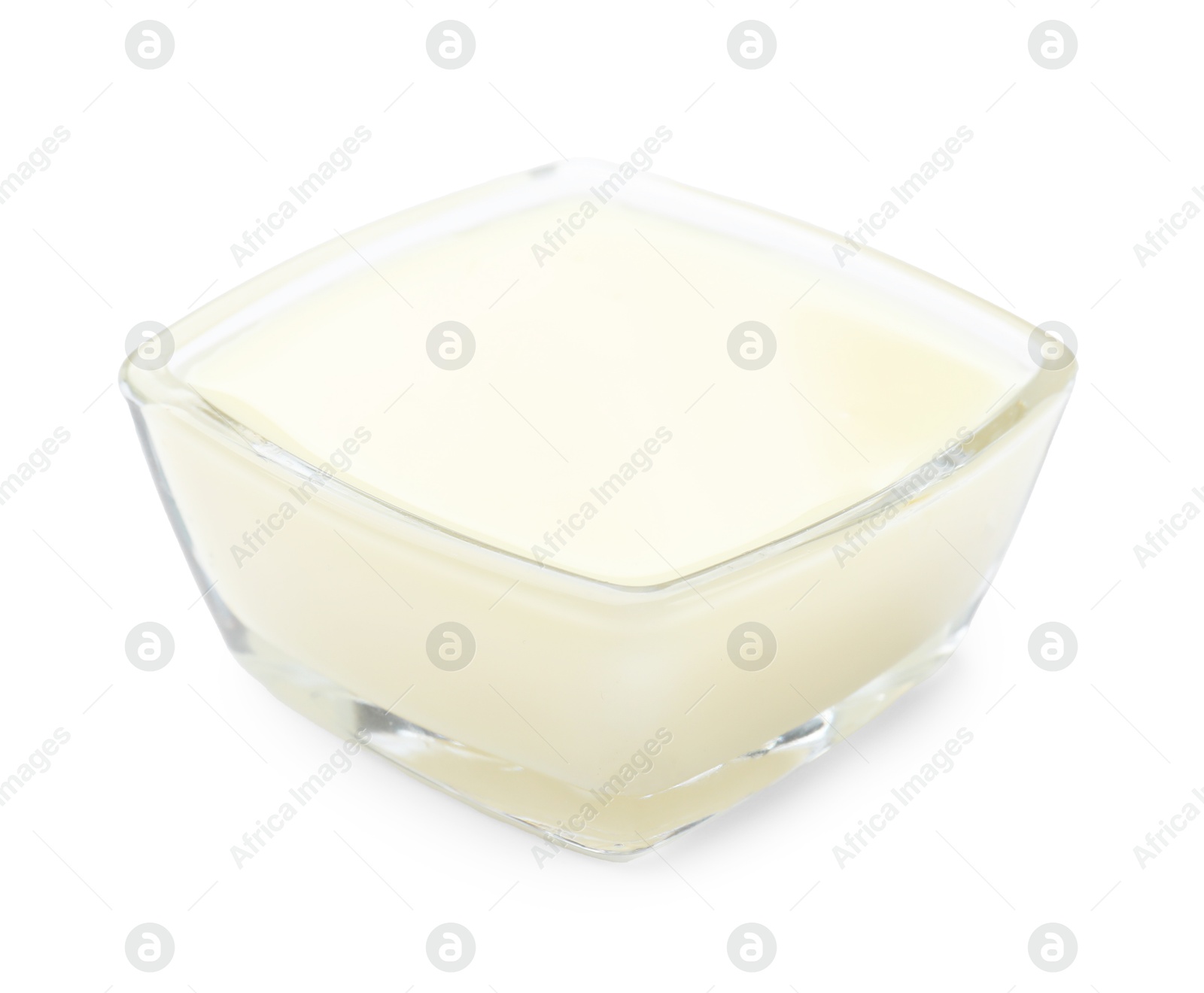 Photo of Condensed milk in bowl isolated on white