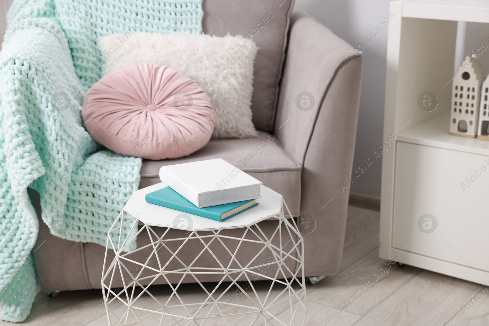 Photo of Stylish coffee table with books at home