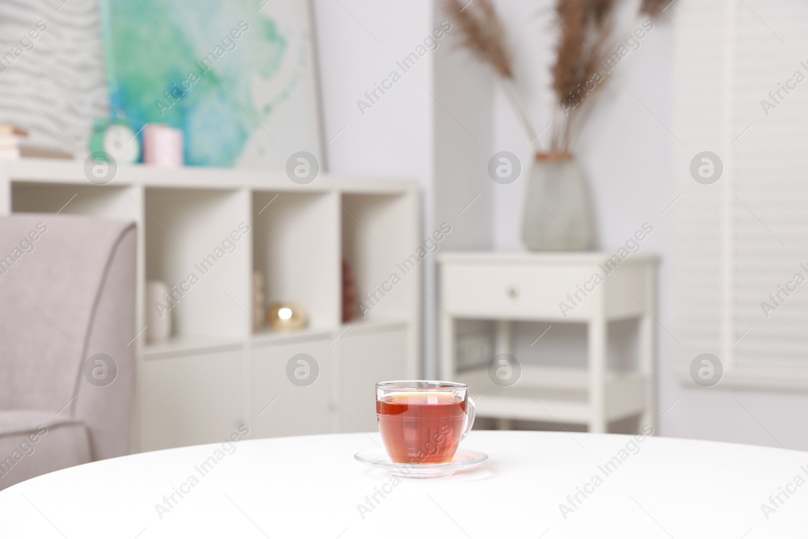 Photo of Stylish coffee table with tea at home, closeup