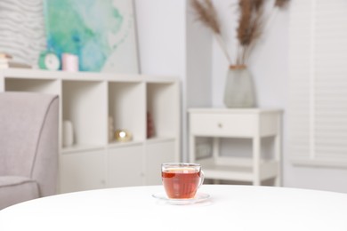 Photo of Stylish coffee table with tea at home, closeup