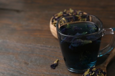 Photo of Delicious butterfly pea flower tea on wooden table. Space for text