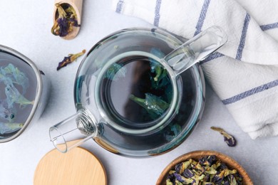 Photo of Delicious butterfly pea flower tea on white table, flat lay