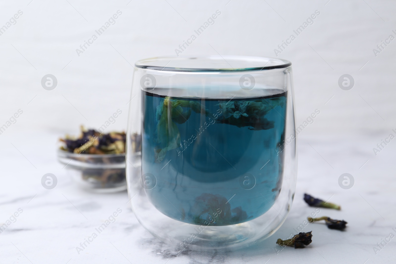 Photo of Delicious butterfly pea flower tea on white marble table