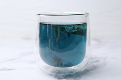 Delicious butterfly pea flower tea on white marble table