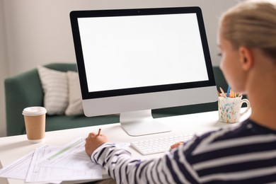 Photo of Woman working at table with computer monitor in office. Mockup for design