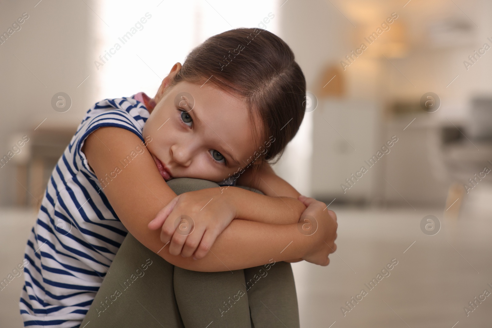 Photo of Orphanage concept. Portrait of sad girl in room