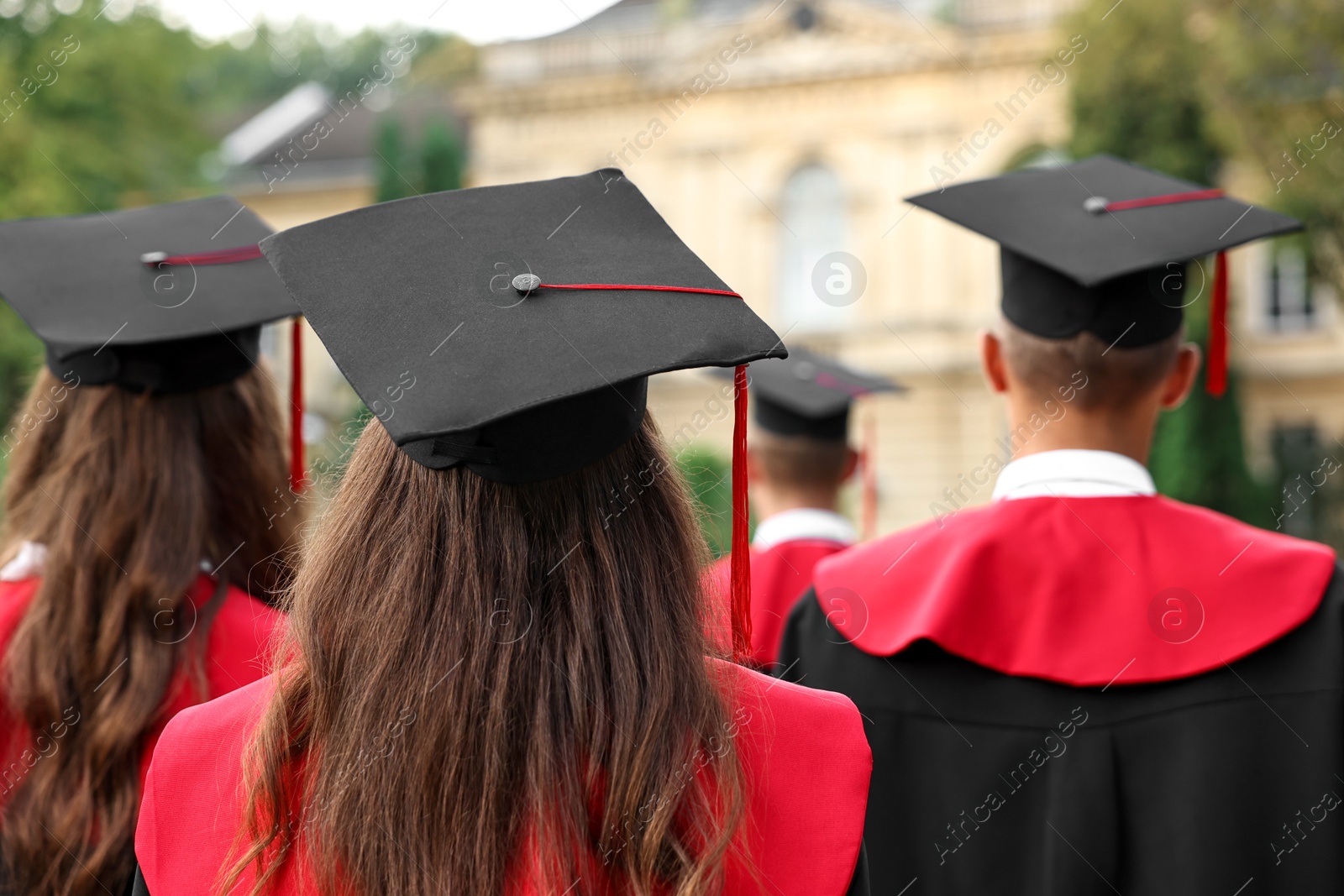 Photo of Students at graduation ceremony outdoors, back view