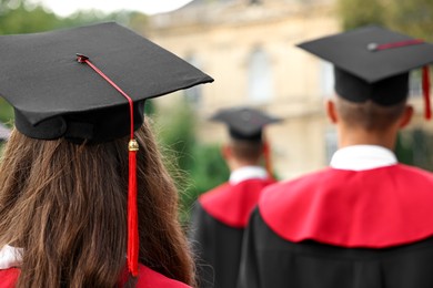 Photo of Students at graduation ceremony outdoors, back view