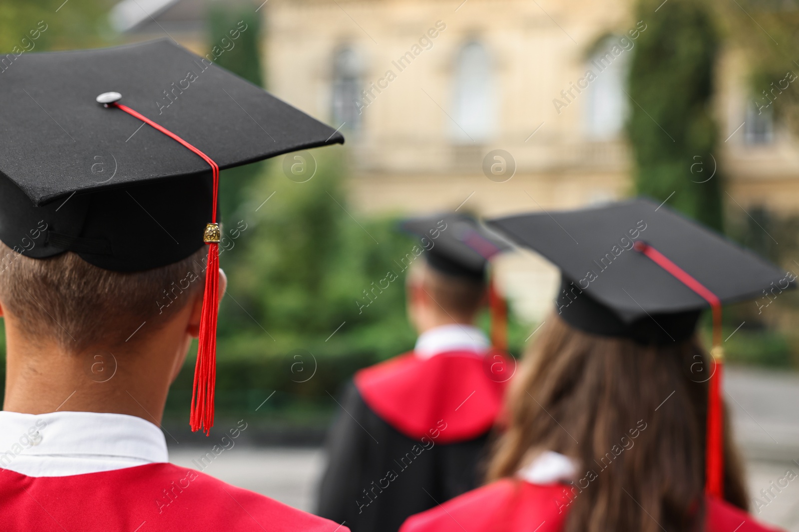 Photo of Students at graduation ceremony outdoors, back view