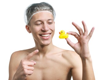 Photo of Happy man in shower cap with bath duck on white background