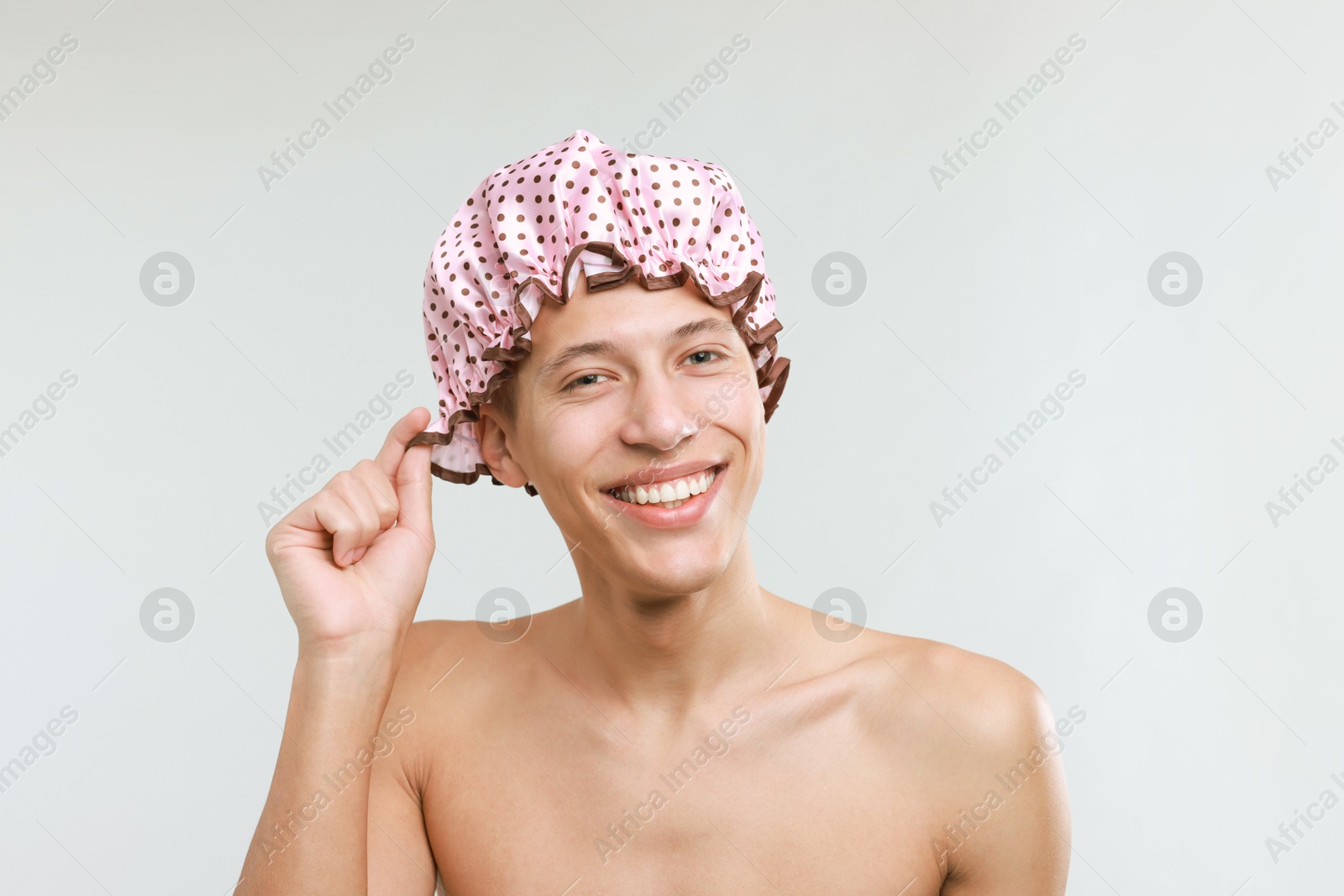 Photo of Man in shower cap on light grey background