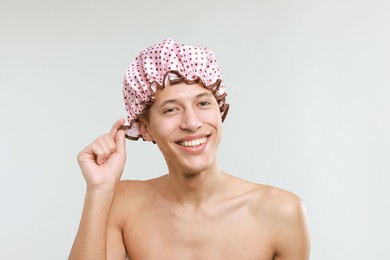 Photo of Man in shower cap on light grey background