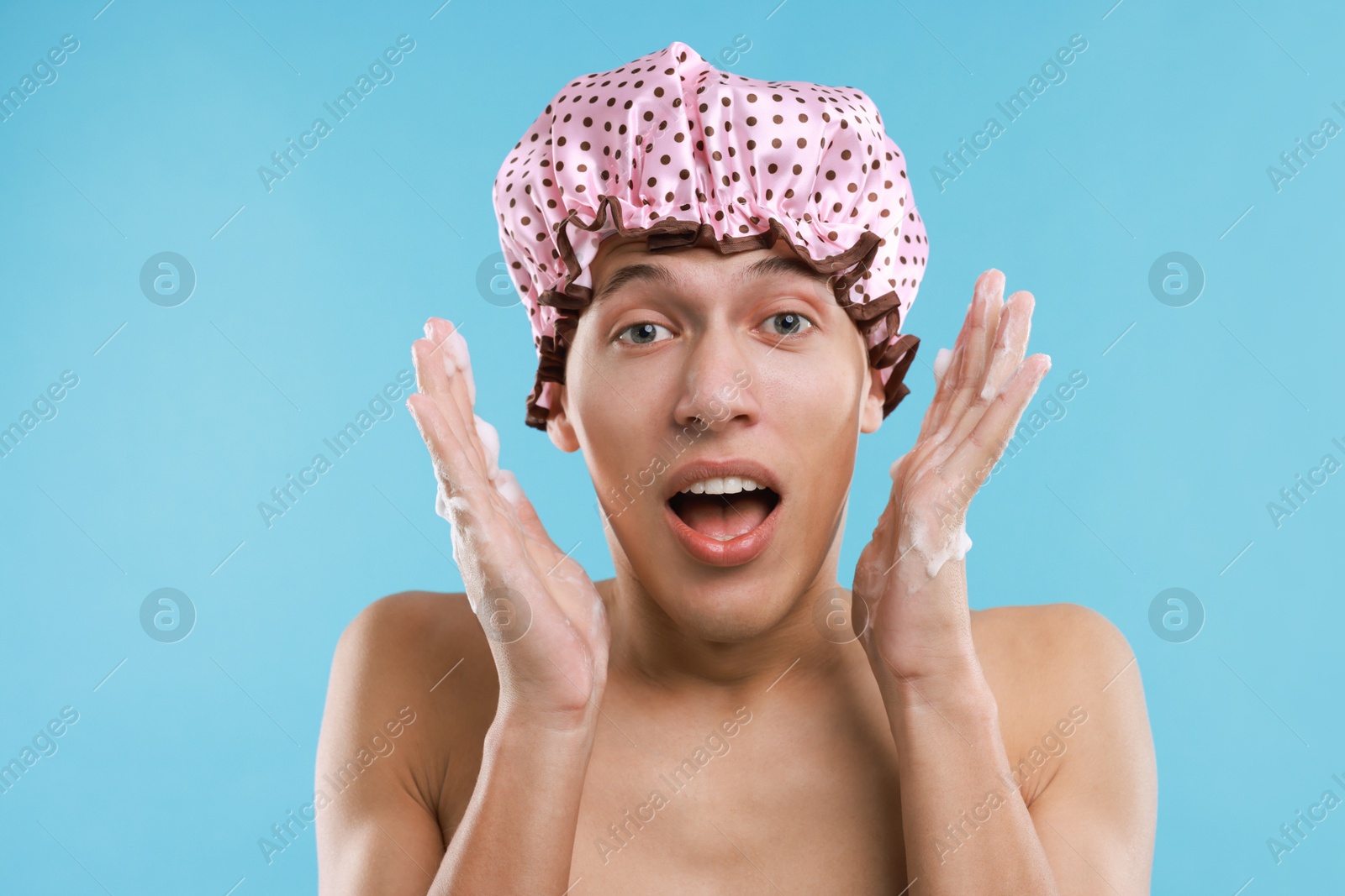 Photo of Man in shower cap on light blue background