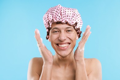 Photo of Man in shower cap on light blue background