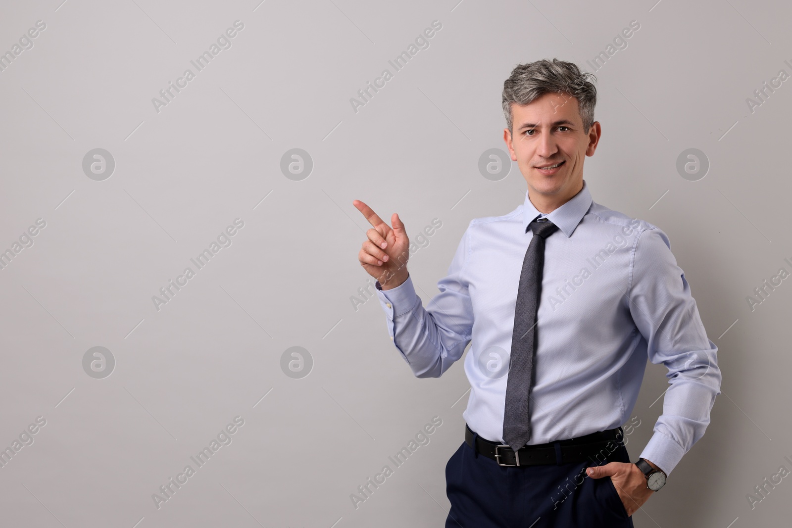 Photo of Portrait of businessman on light grey background, space for text