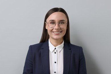 Photo of Portrait of businesswoman in glasses on light grey background