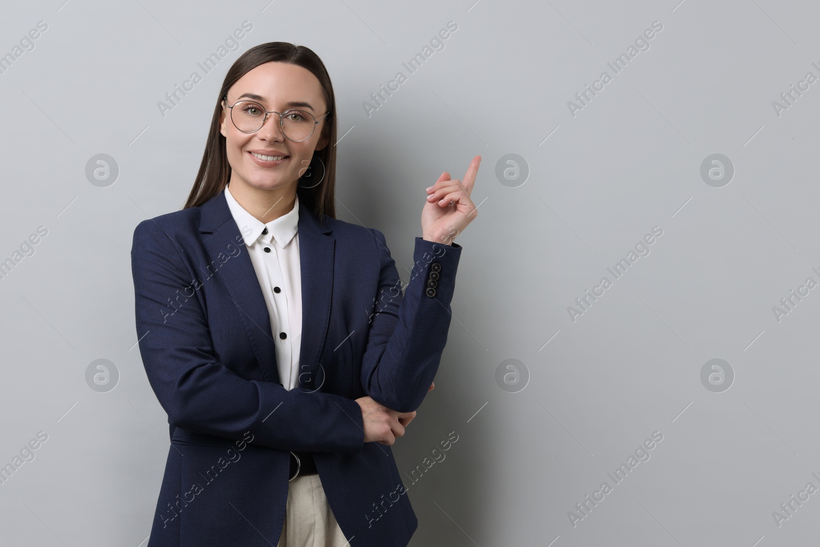 Photo of Portrait of businesswoman in glasses on light grey background, space for text