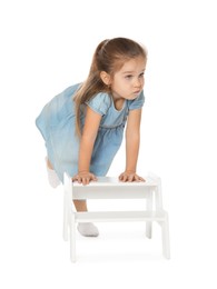 Photo of Little girl with step stool on white background