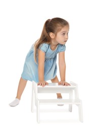 Photo of Little girl with step stool on white background