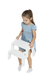 Photo of Little girl with step stool on white background