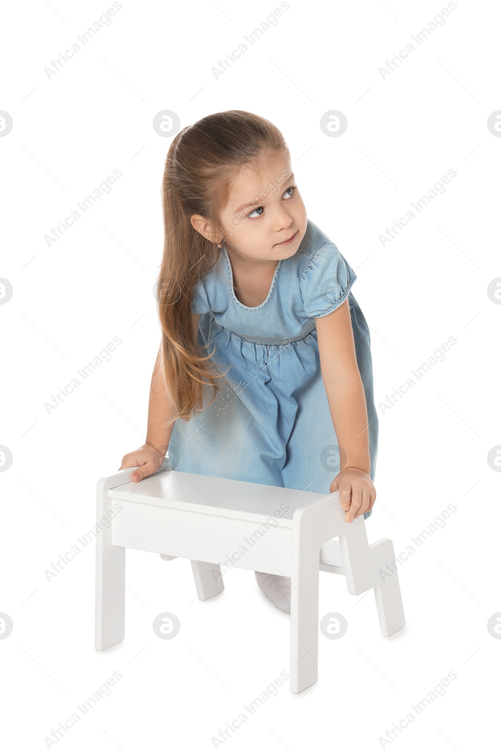 Photo of Little girl with step stool on white background