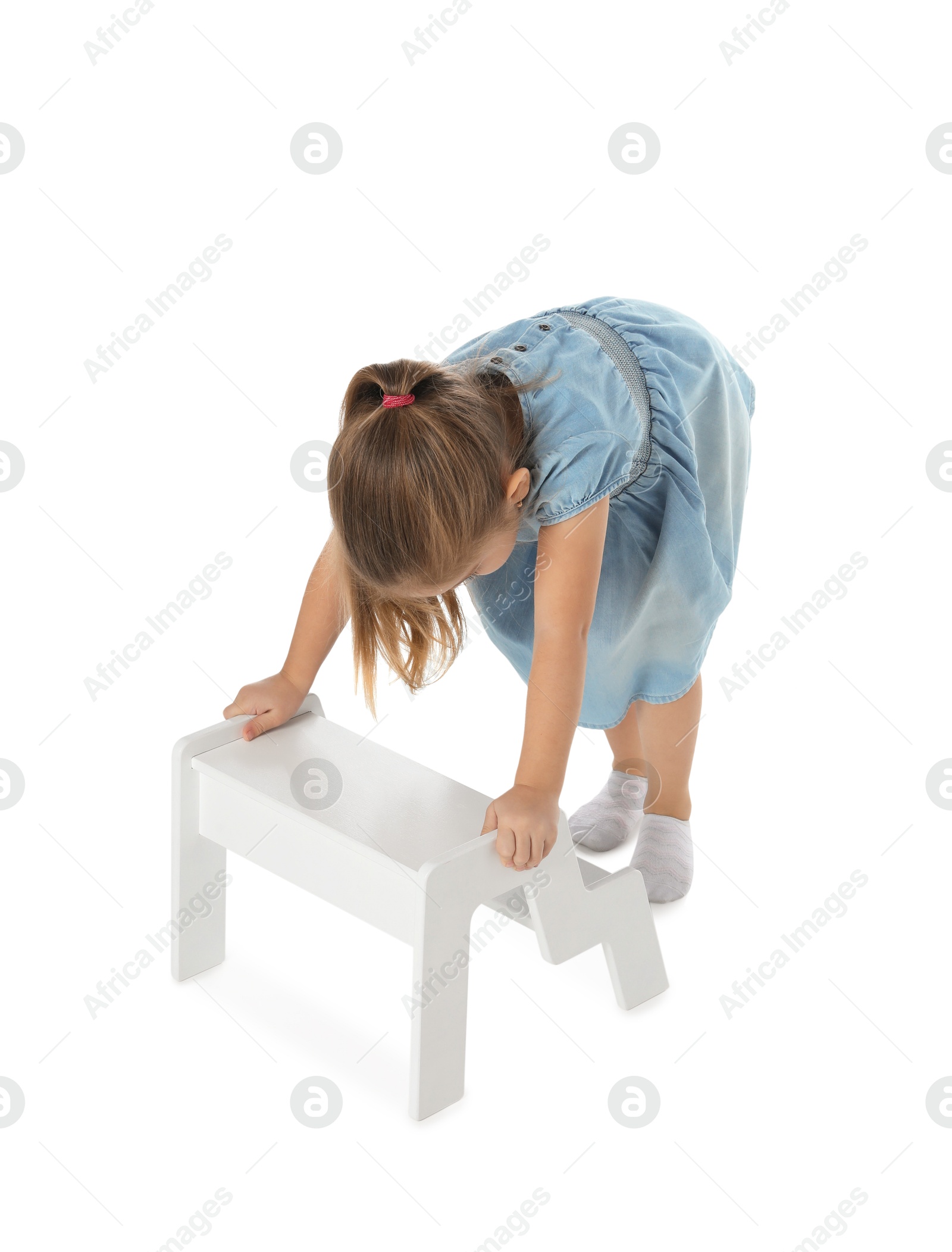 Photo of Little girl with step stool on white background