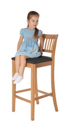 Photo of Little girl sitting on stool against white background