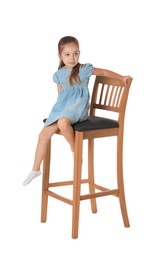 Photo of Little girl sitting on stool against white background