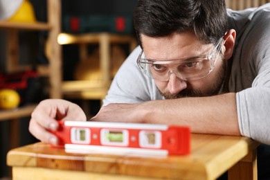 Repairman checking stool level in workshop, closeup