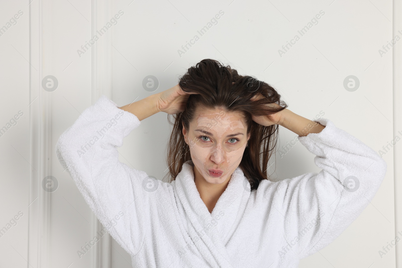 Photo of Spa day. Beautiful woman with face mask indoors