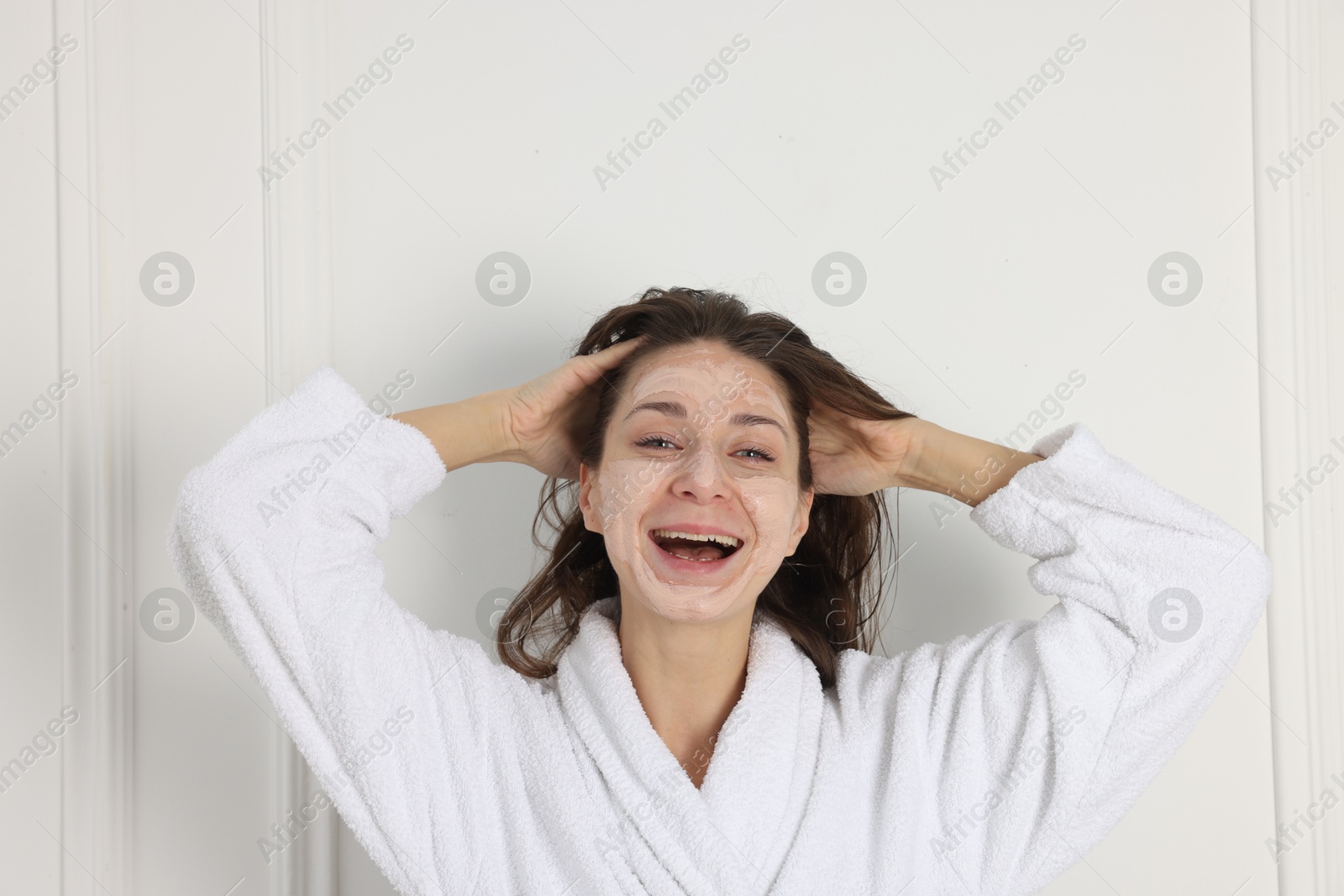 Photo of Spa day. Beautiful woman with face mask indoors