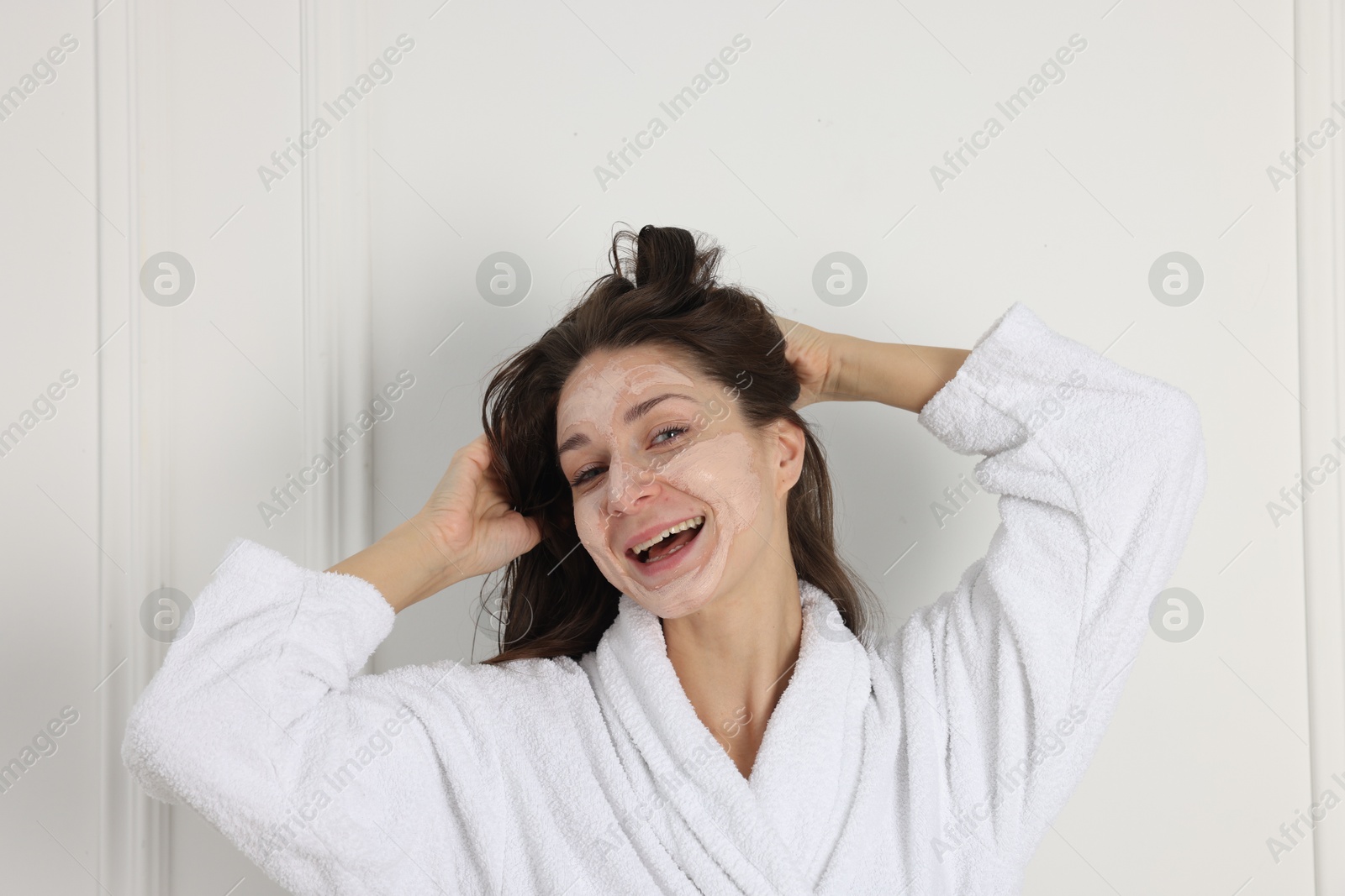 Photo of Spa day. Beautiful woman with face mask indoors