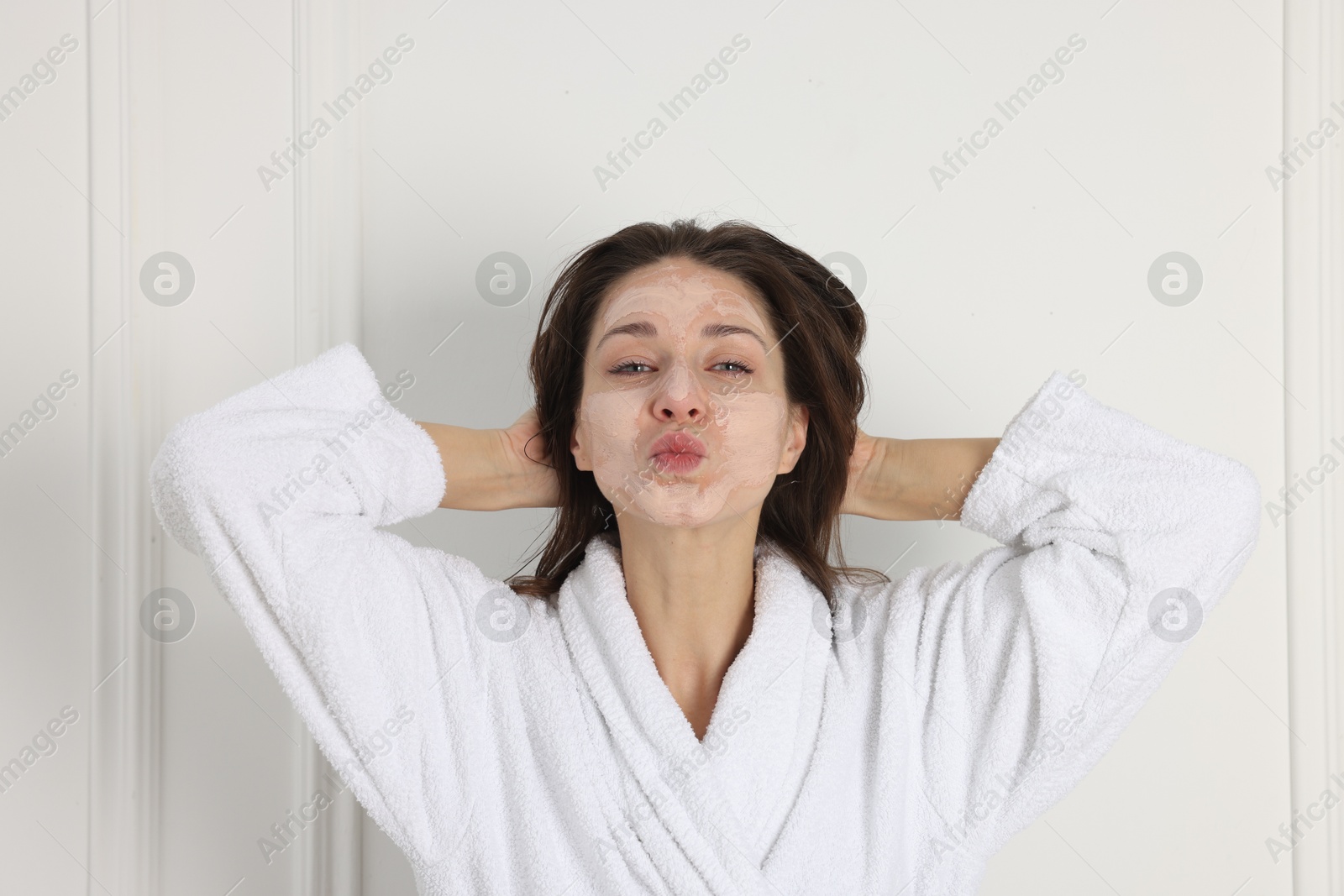 Photo of Spa day. Beautiful woman with face mask indoors