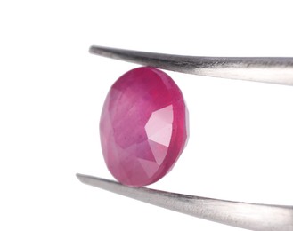 Photo of Tweezers with shiny pink gemstone isolated on white