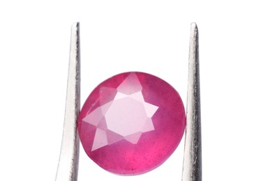 Photo of Tweezers with shiny pink gemstone isolated on white