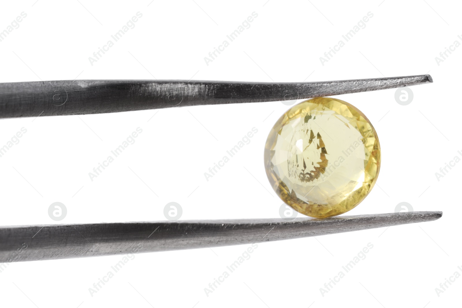 Photo of Tweezers with shiny yellow gemstone isolated on white