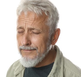 Sad senior man crying on white background