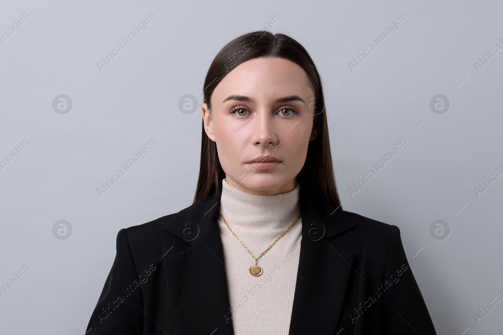 Photo of Portrait of businesswoman on light grey background