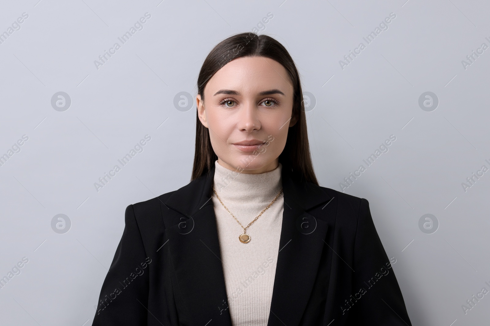 Photo of Portrait of businesswoman on light grey background