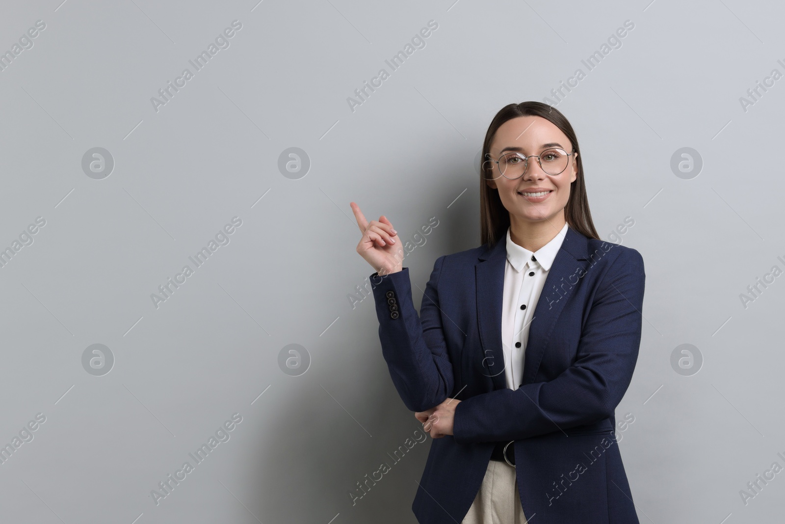 Photo of Portrait of businesswoman in glasses on light grey background, space for text