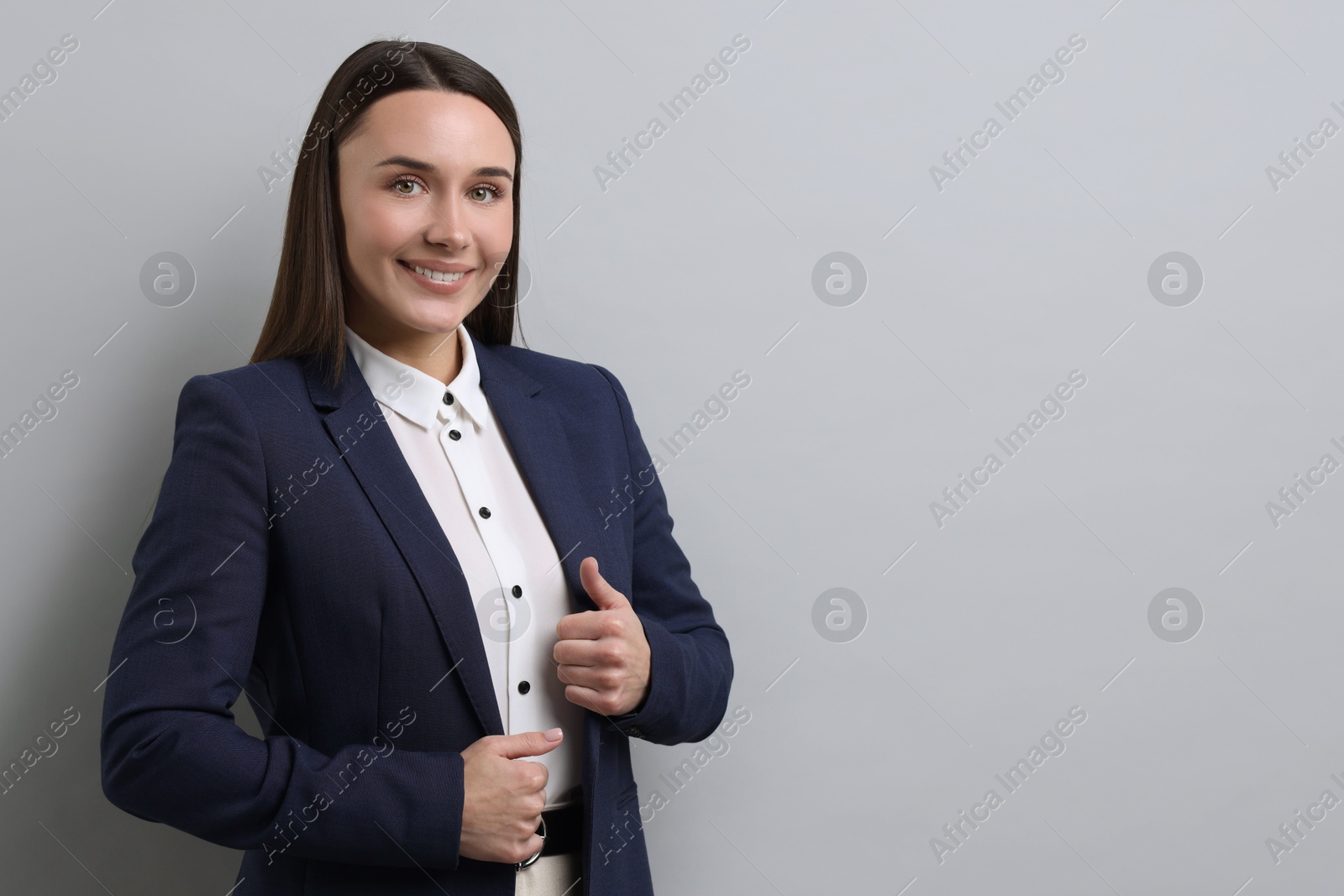 Photo of Portrait of businesswoman on light grey background, space for text