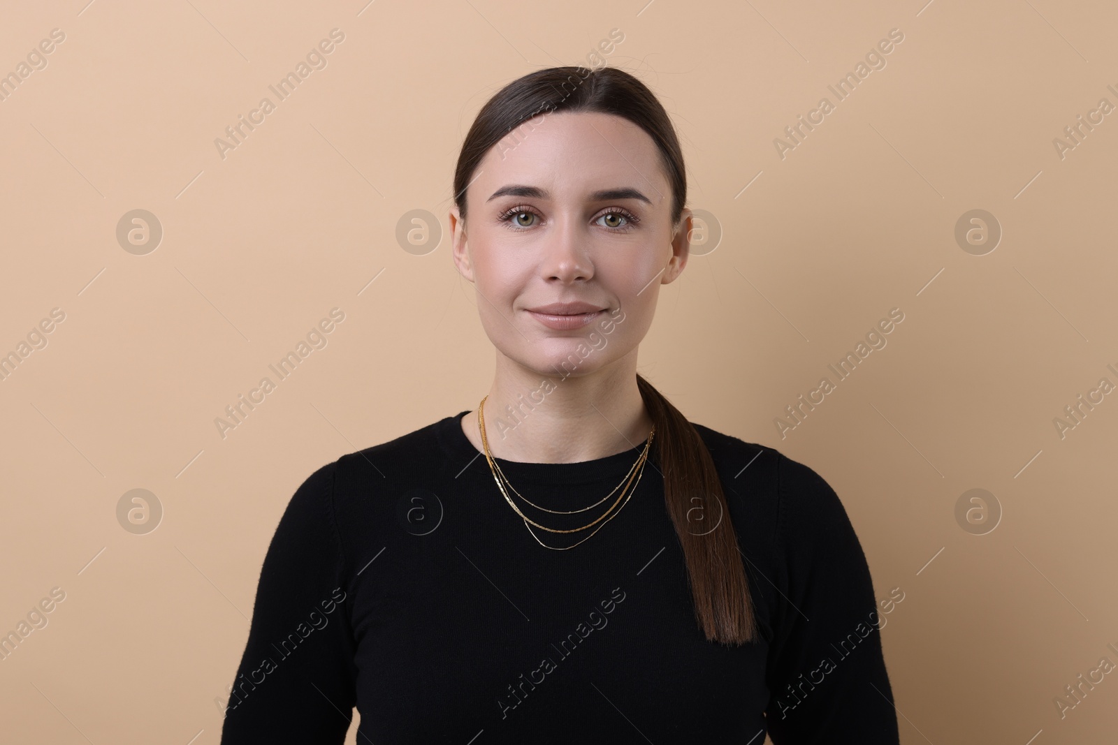 Photo of Portrait of beautiful businesswoman on beige background