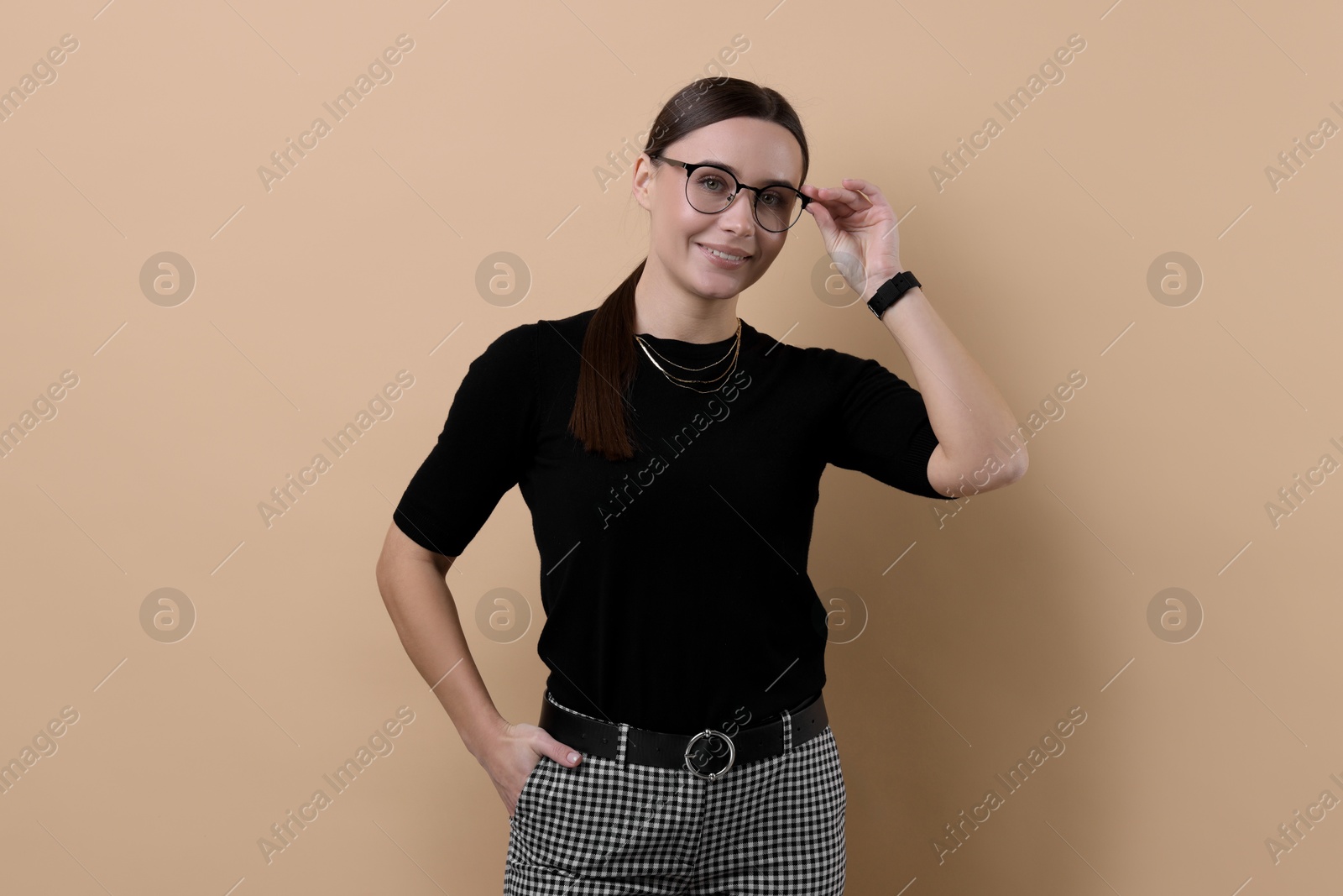 Photo of Portrait of businesswoman in glasses on beige background